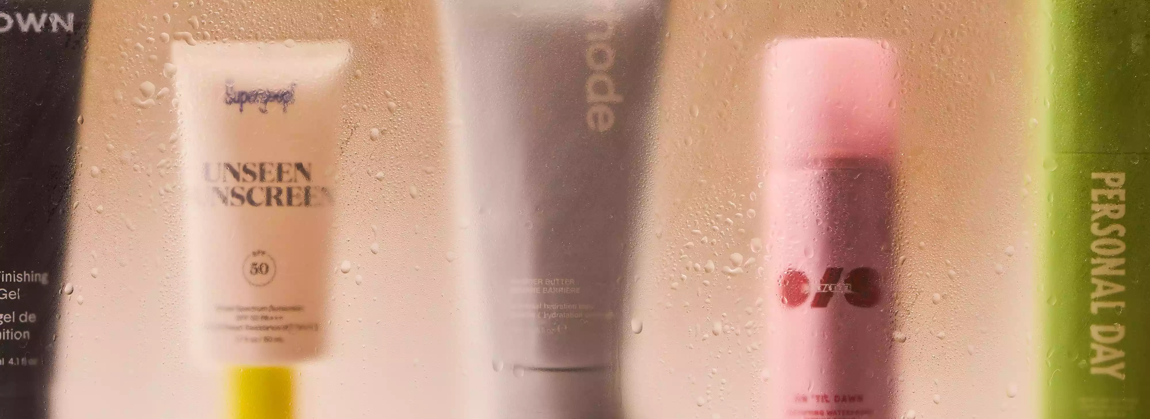 beauty products behind sweaty glass