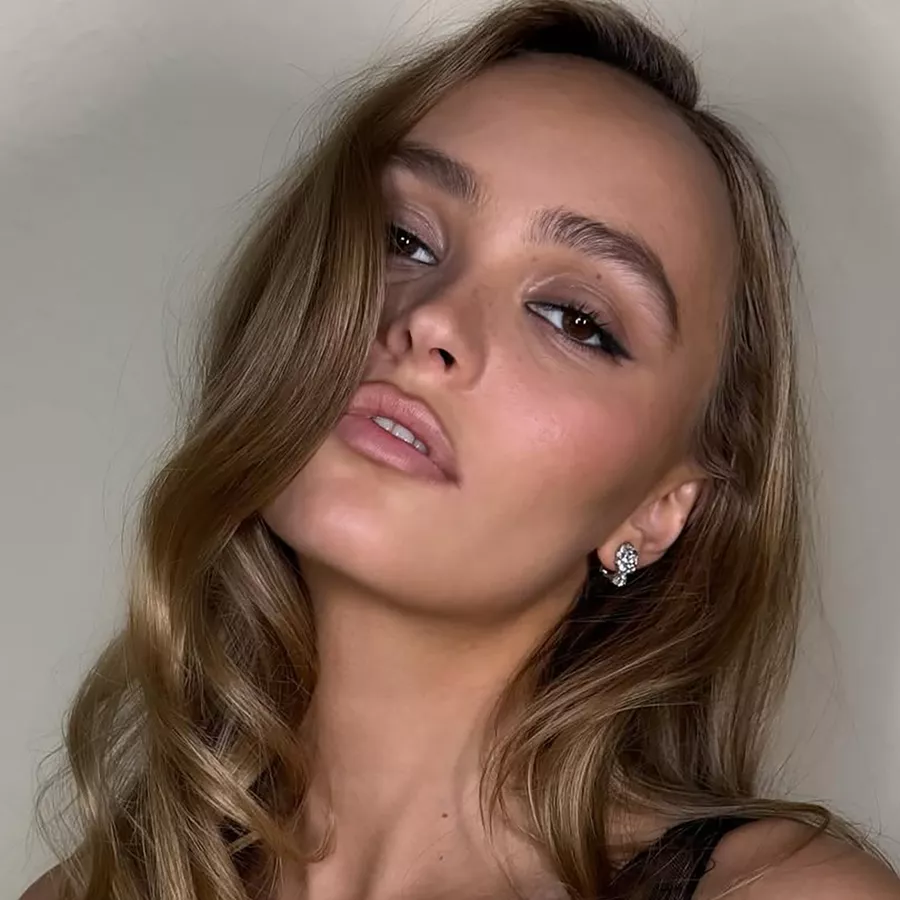 Actor Lily-Rose Depp with ash brown hair in cascading waves