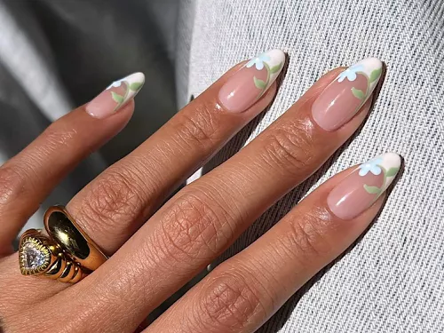 a french manicure with blue flowers and green stem details